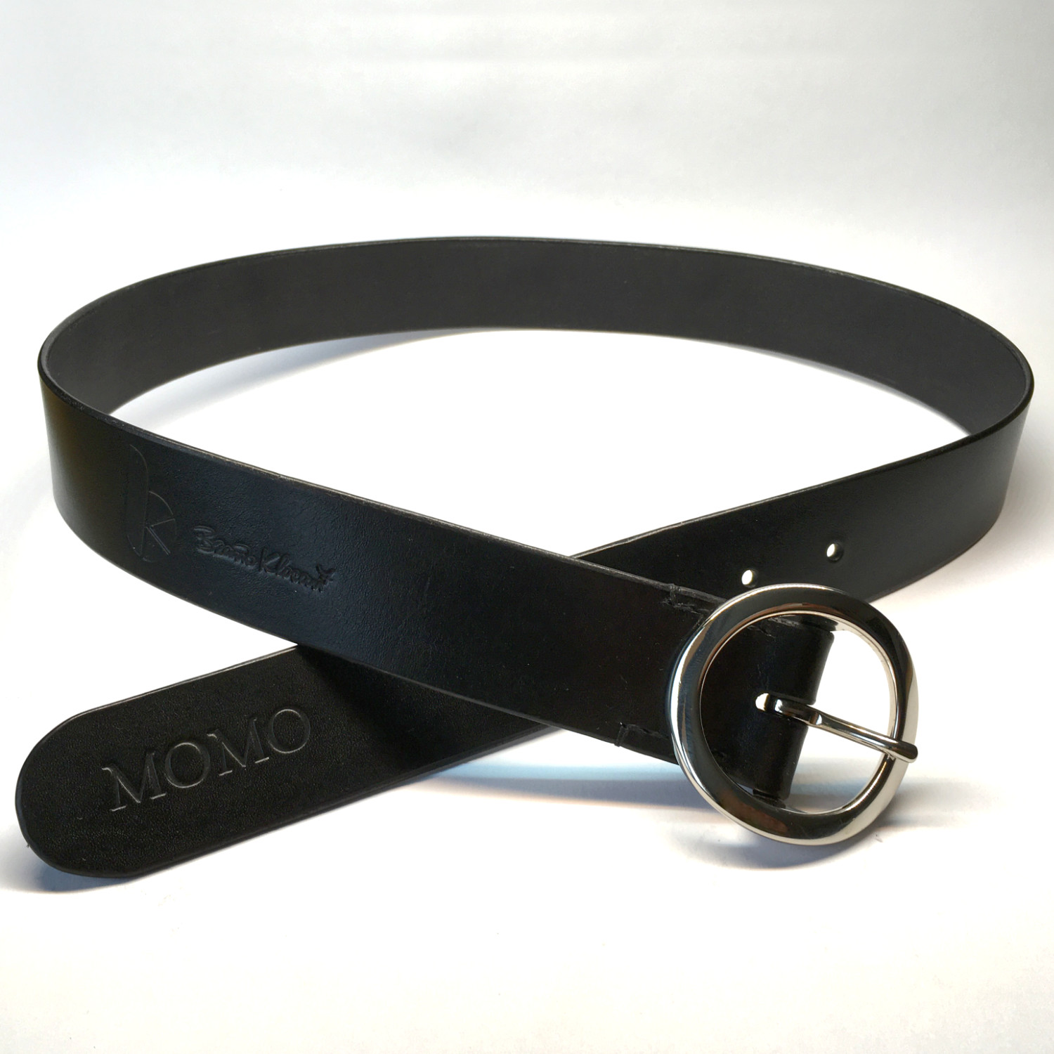 black leather belt with round silver buckle